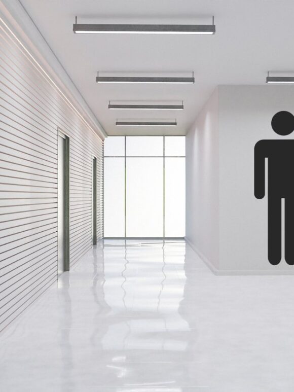 Indications et symboles des toilettes sur un mur blanc